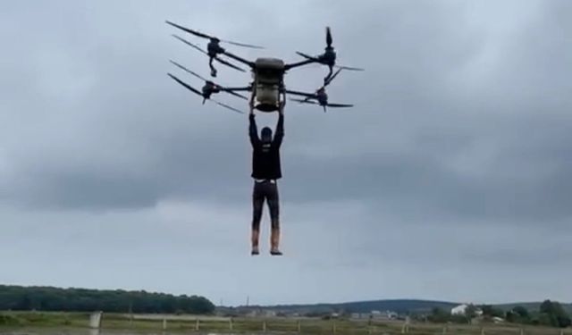 Çiftçi, drona tutunarak tarlanın diğer tarafına geçti